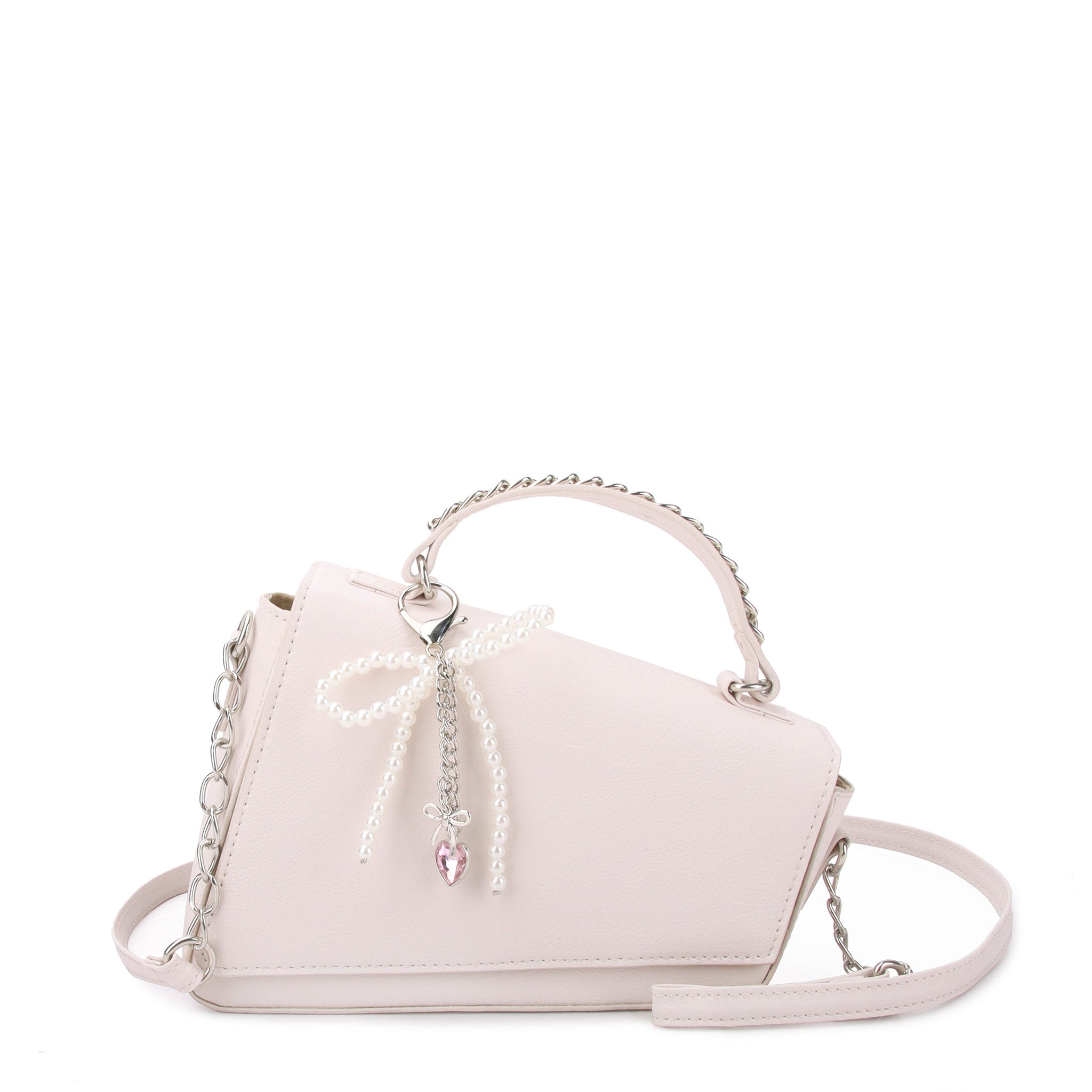 front view of white angled flap front crossbody bag with a pearl bow charm