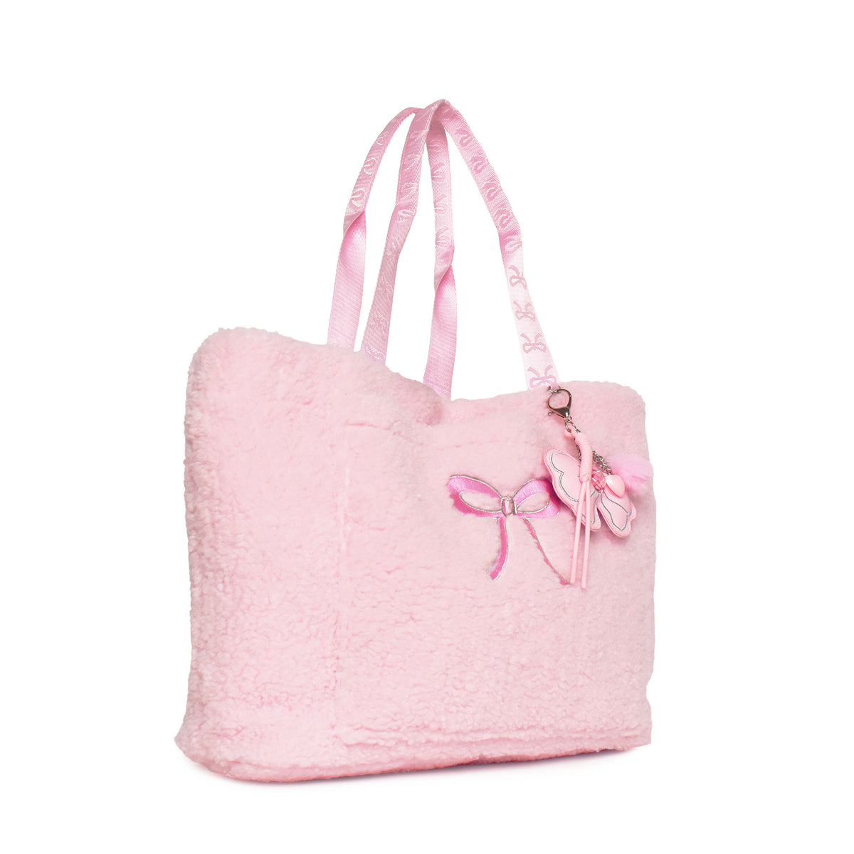A light pink fuzzy tote bag with matching pink shoulder straps, featuring an embroidered pink bow on the front and a bow-shaped charm with a rhinestone accent.