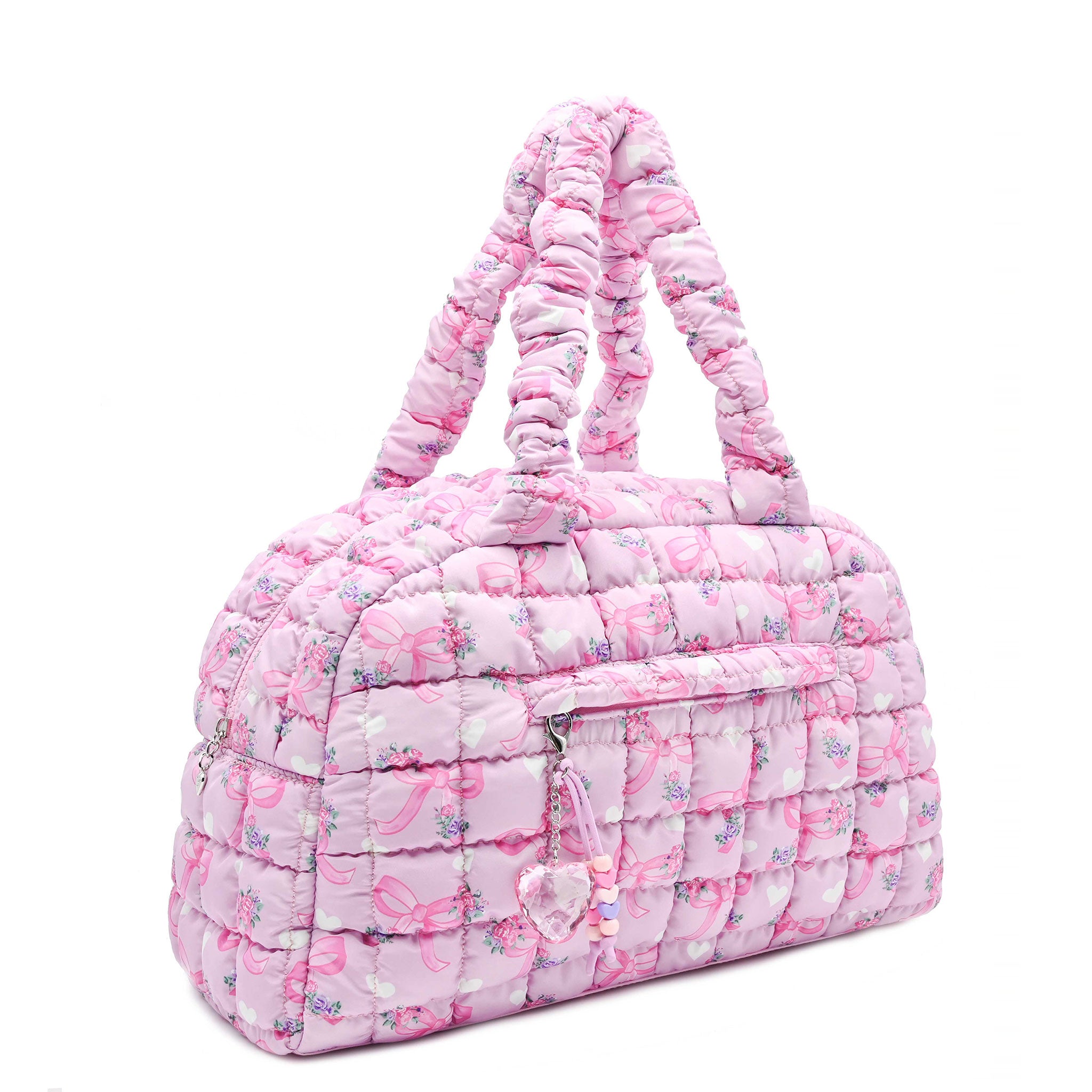 3/4 acing view of a pink medium sized quilted scrunch nylon duffle bag with a bow/heart/floral print and front beaded zipper pocket with a crystal heart charm