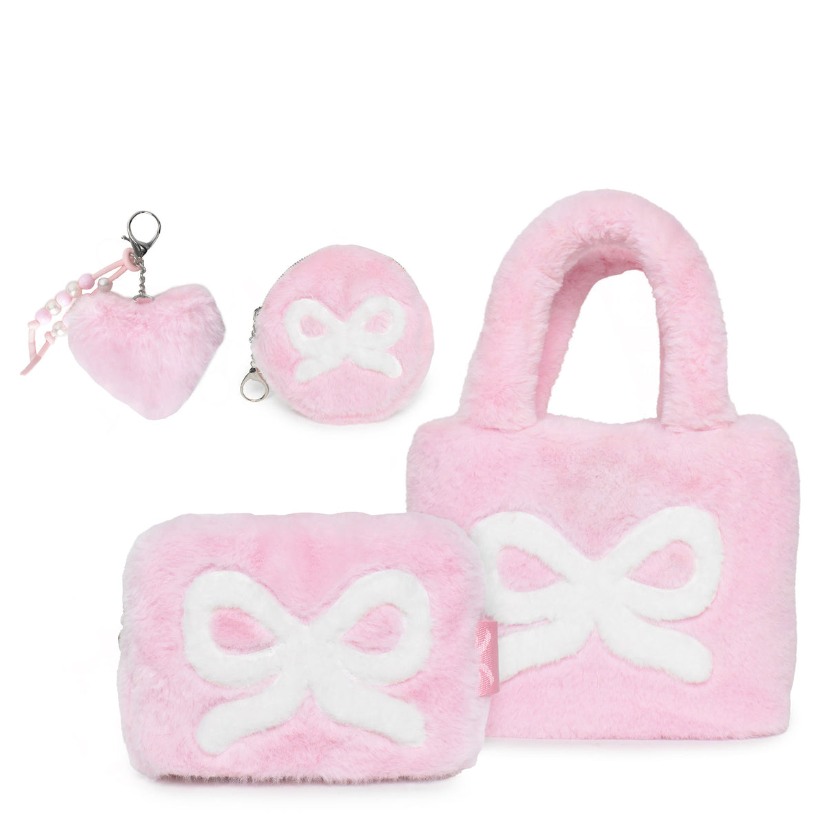 A pink plush gift set containing a large bow-patterned mini tote, a small round pouch , a plush heart and faux pearl keychain, and a small rectangular pouch, all in soft pink with white bow accents.