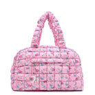 front facing view of a pink medium sized quilted scrunch nylon duffle bag with a floral print and front beaded zipper pocket with a crystal heart charm