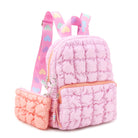 3/4 angle facing view of a pink nylon quilted mini backpack with orange zipper closure front pocket and orange coin purse