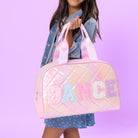 front view of a medium metallic quilted duffle bag with varsity lettering "DANCE" 