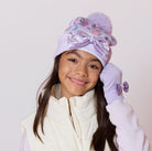model wearing a purple floral print pom pom hat with matching gloves