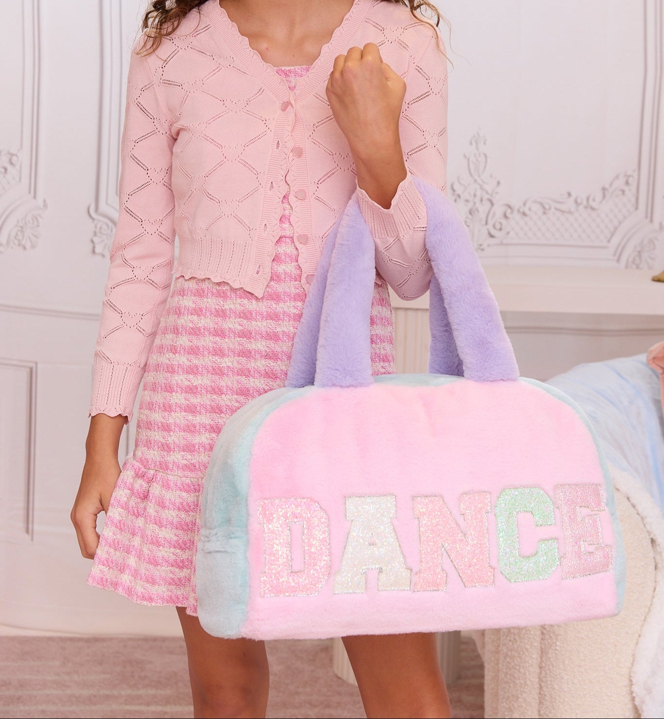 model holding plush color block 'DANCE' duffle