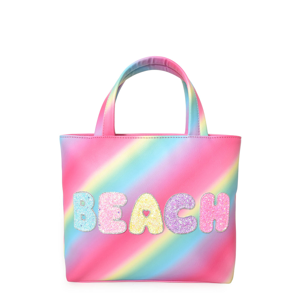 Front view of a rainbow ombre mini tote bag embellished with glitter bubble letters 'BEACH' appliqué.