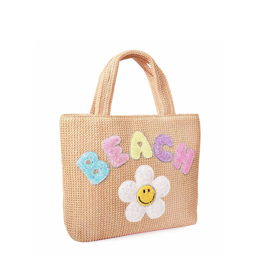 Side View of a Mini Straw Beach Tote Bag with Applique 'Beach' bubble letters and glitter daisy