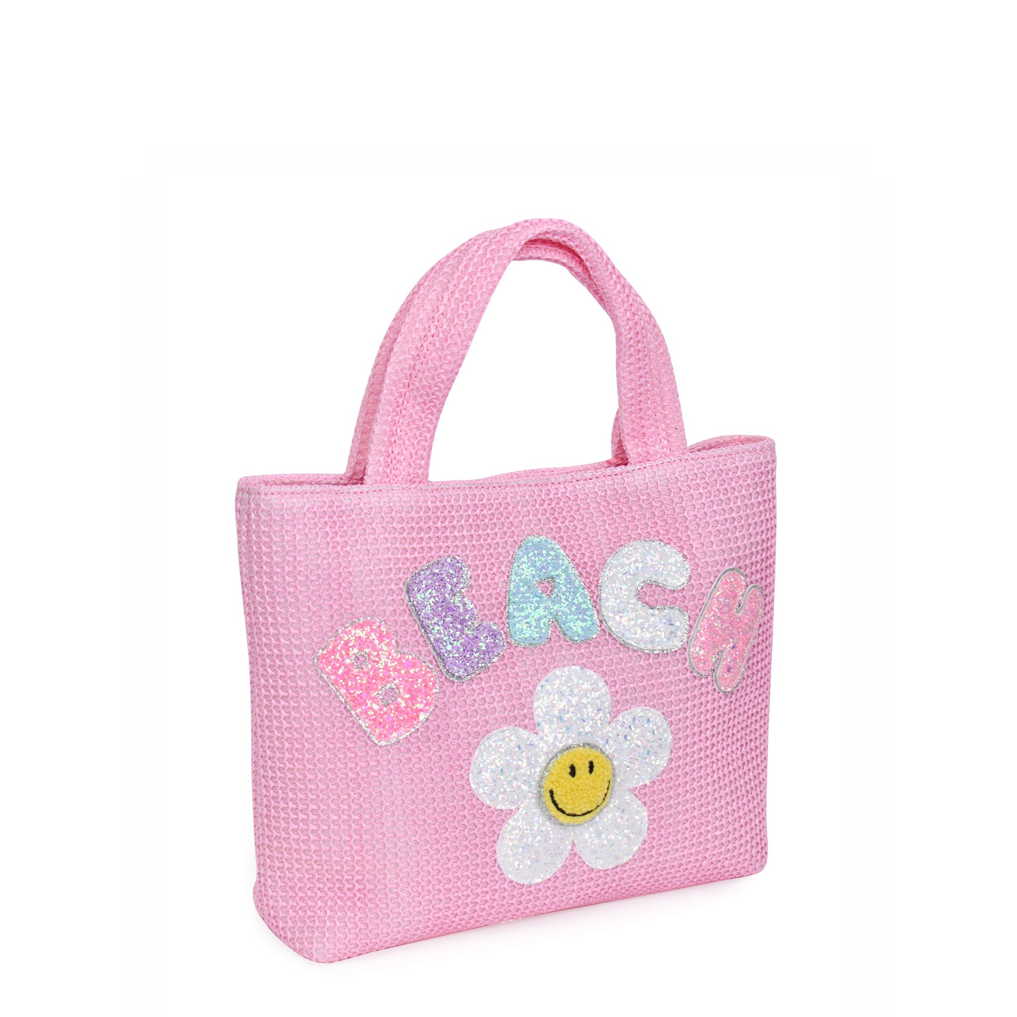 Side view of mini pink straw 'Beach' tote bag with smiley daisy patch
