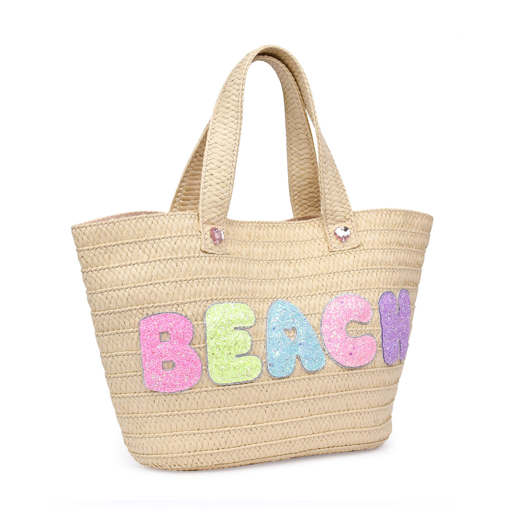 Side view of straw beach tote with glitter bubble letters 'BEACH' appliqué