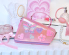 Pink and Lavender Angled Crossbody Bag with Butterfly, Heart, and Daisy Appliques on top of vanity 