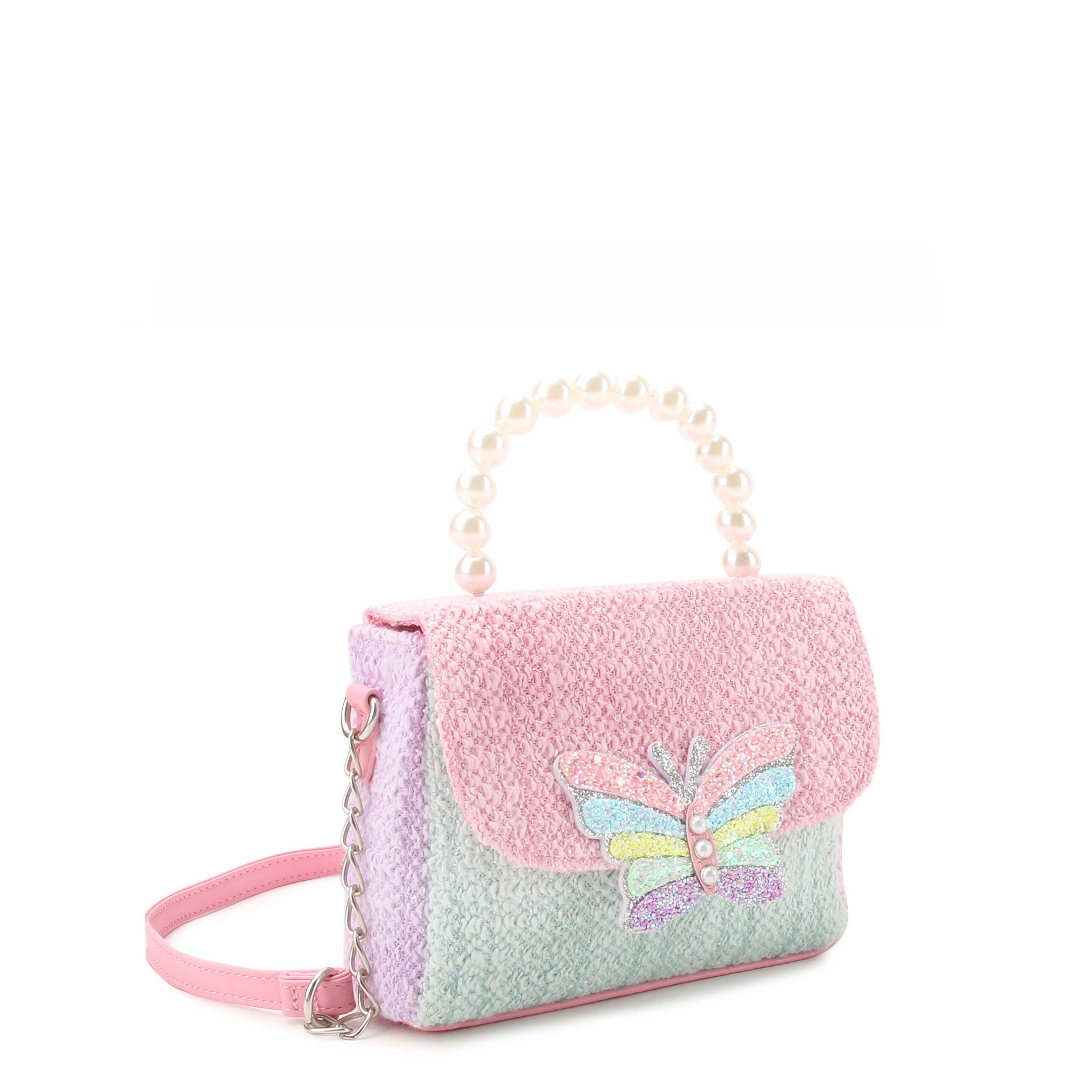 side  view of a colorblock tweed crossbody bag with a glitter butterfly appliqué with a pearl top handle 