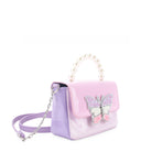 side view of a colorblocked vinyl flap front crossbody  with a pearl beaded top handle with a glitter butterfly appliqué 