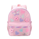 front facing view of a large pink backpack with a front zipper closure pocket and glitter butterfly, heart, and flower appliqués 