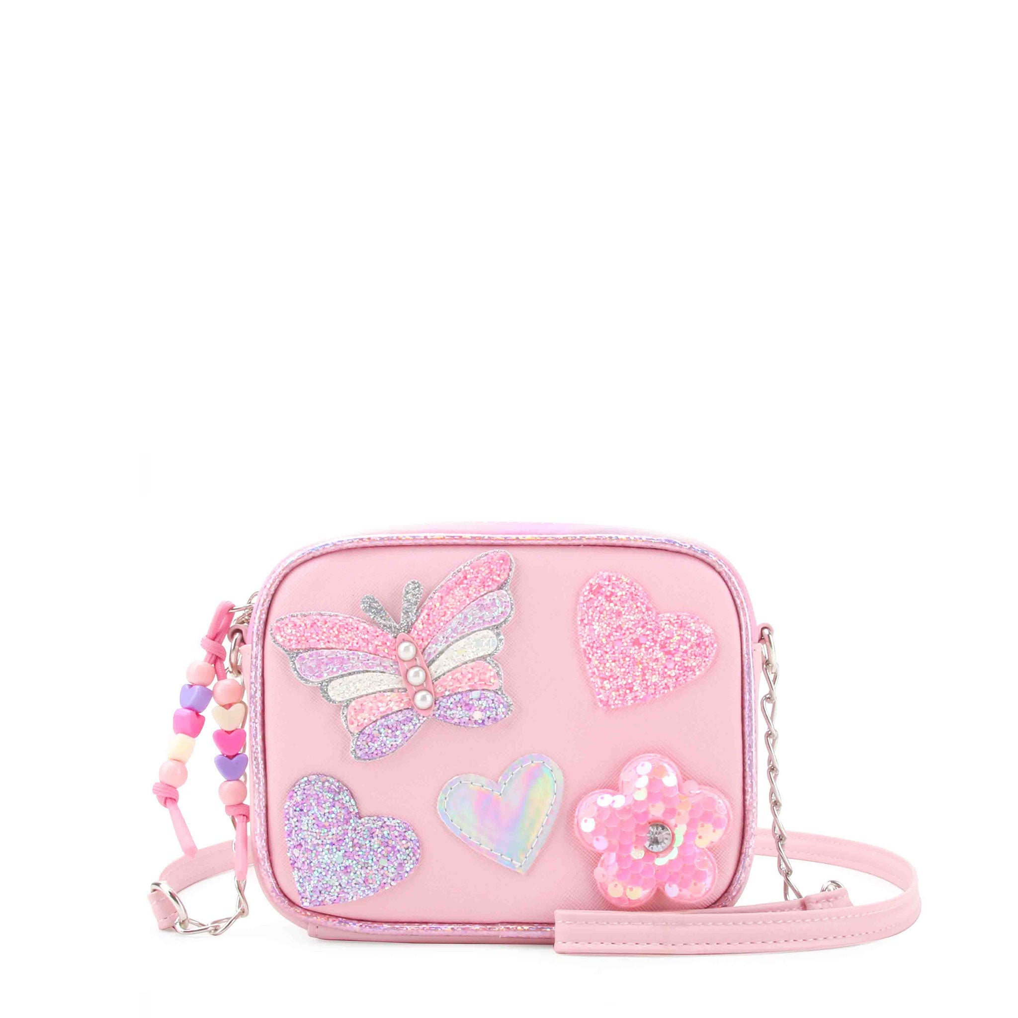 pink crossbody bag with beaded zipper pull and glitter butterfly, heart, and sequin daisy appliqués 