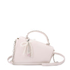 front view of white angled flap front crossbody bag with a pearl bow charm