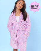 Girl model wearing a lavender floral bow print robe with a blue background