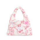 A plush, fuzzy handbag in a pink and white marbled pattern, decorated with various bows and a flower applique in shades of pink and iridescent.