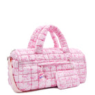 3/4 facing view of a pink large sized quilted scrunch nylon duffle bag with a bow print and front beaded zipper pocket with a crystal heart charm and matching detachable coin pouch