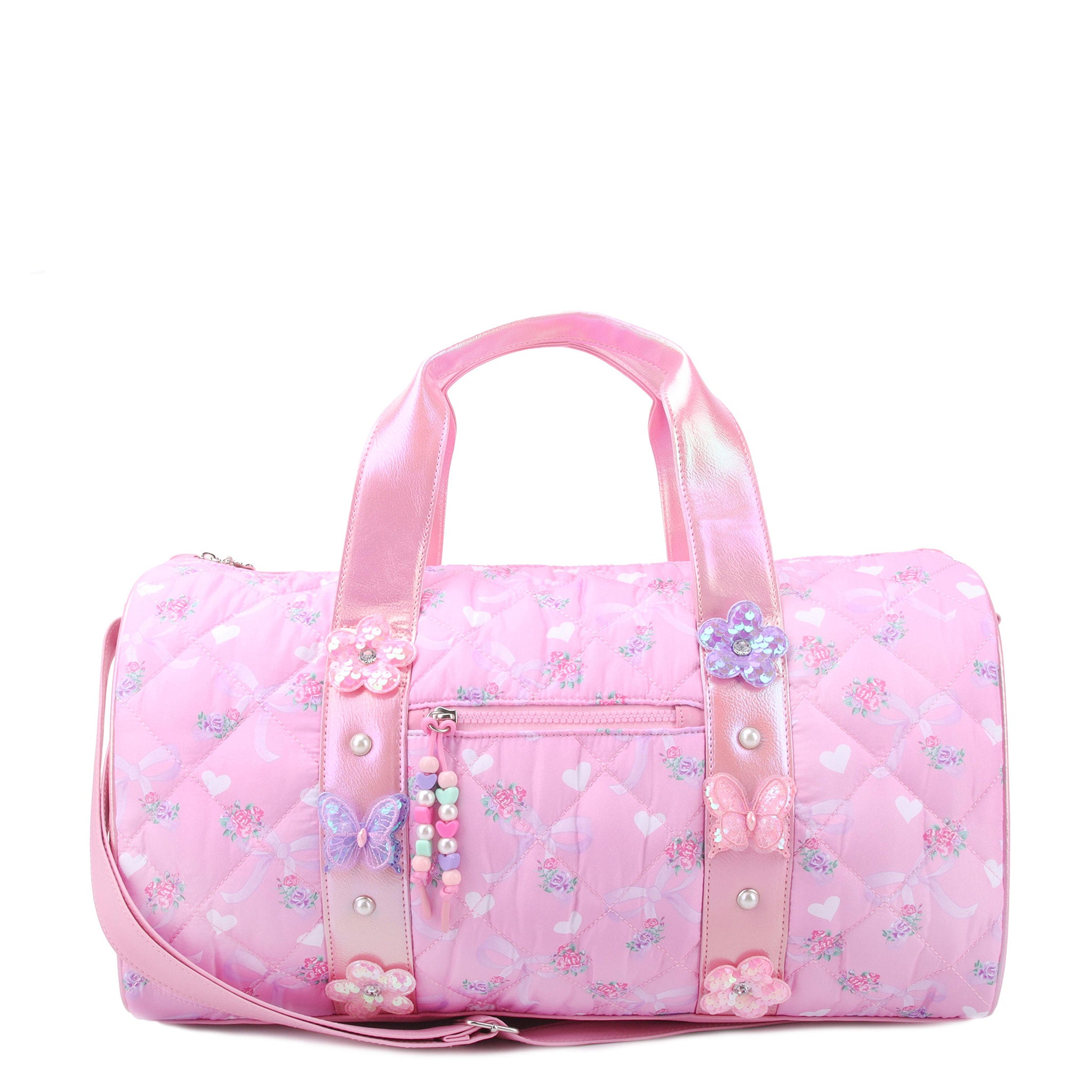 front view of a floral bow printed barrel duffle bag with butterfly & daisy appliques. pink metallic straps & beaded zipper pull