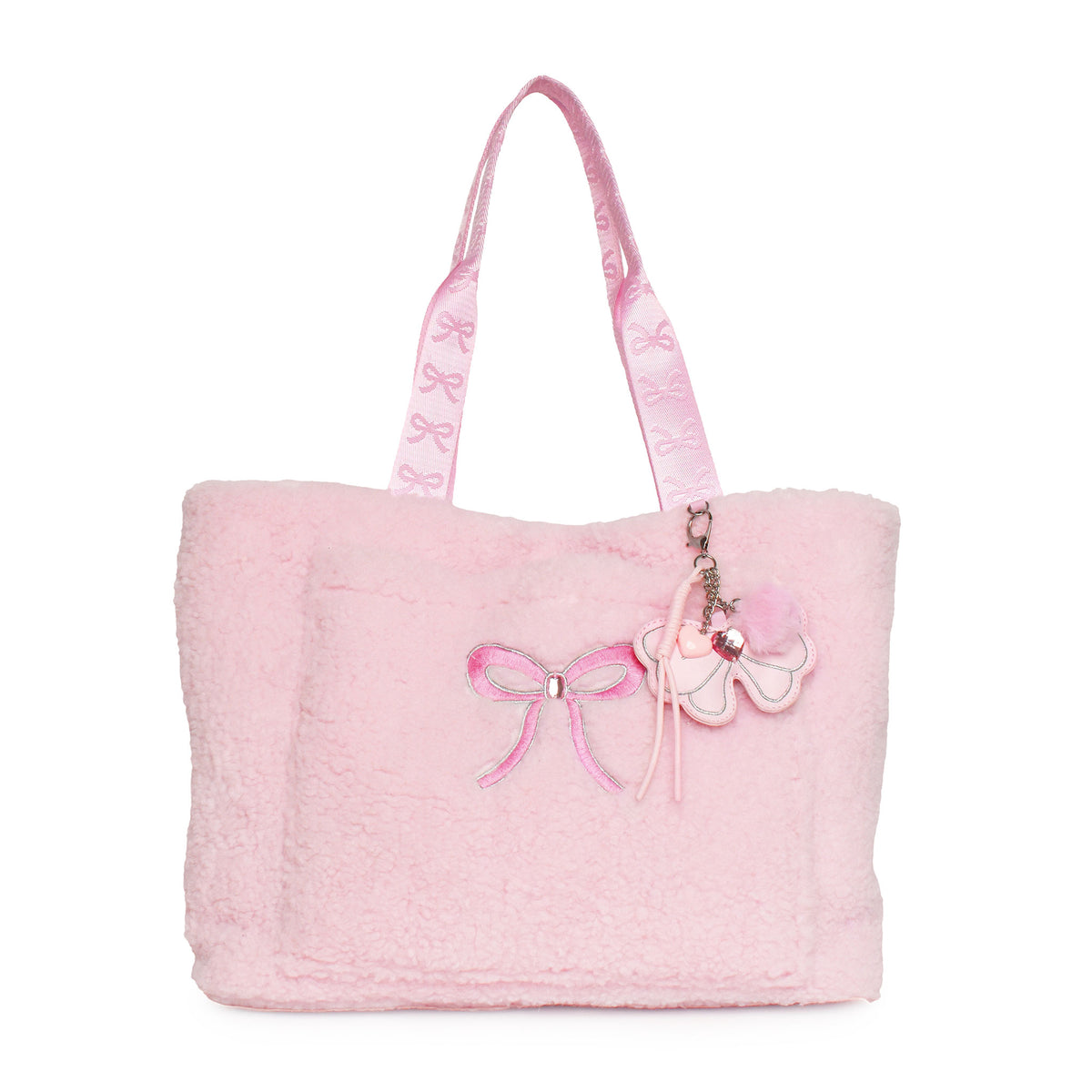 A light pink fuzzy tote bag with matching pink shoulder straps, featuring an embroidered pink bow on the front and a bow-shaped charm with a rhinestone accent.