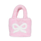 A pink plush mini tote handbag with a white bow design on the front, photographed against a solid white background.