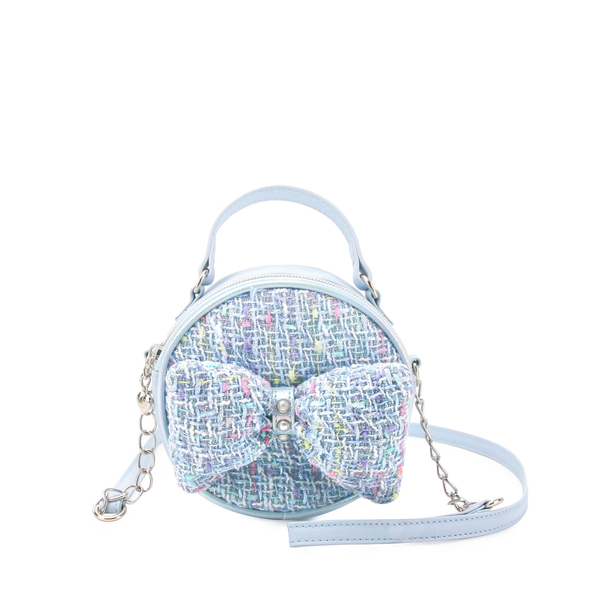 front facing view of a circular blue tweed mini bag with a top handle and matching blue tweed bow detail on the front.