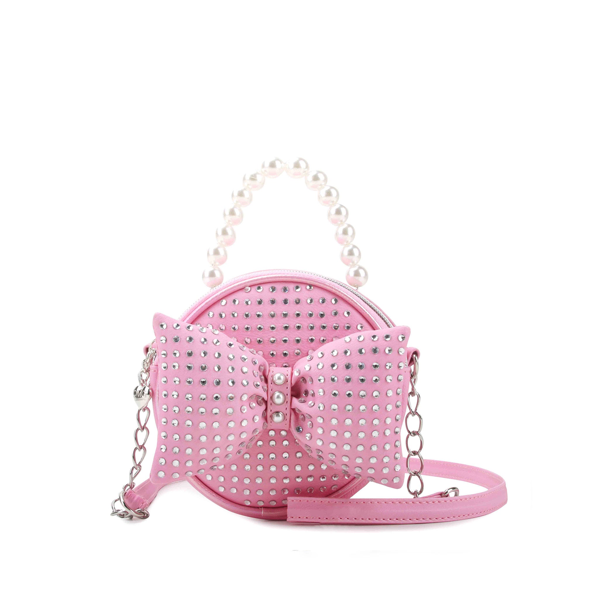 Pink circle shaped handbag covered in rhinestone studs with a puffy bow and pearl topped handle