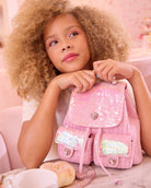 photoshoot photo of a pink sequin & tweed drawstring mini backpack with a pearl beaded top handle