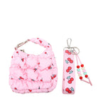 front view of a quilted pink cherry printed crescent shaped keychain and a pink cherry printed lanyard keychain with beaded detailing.
