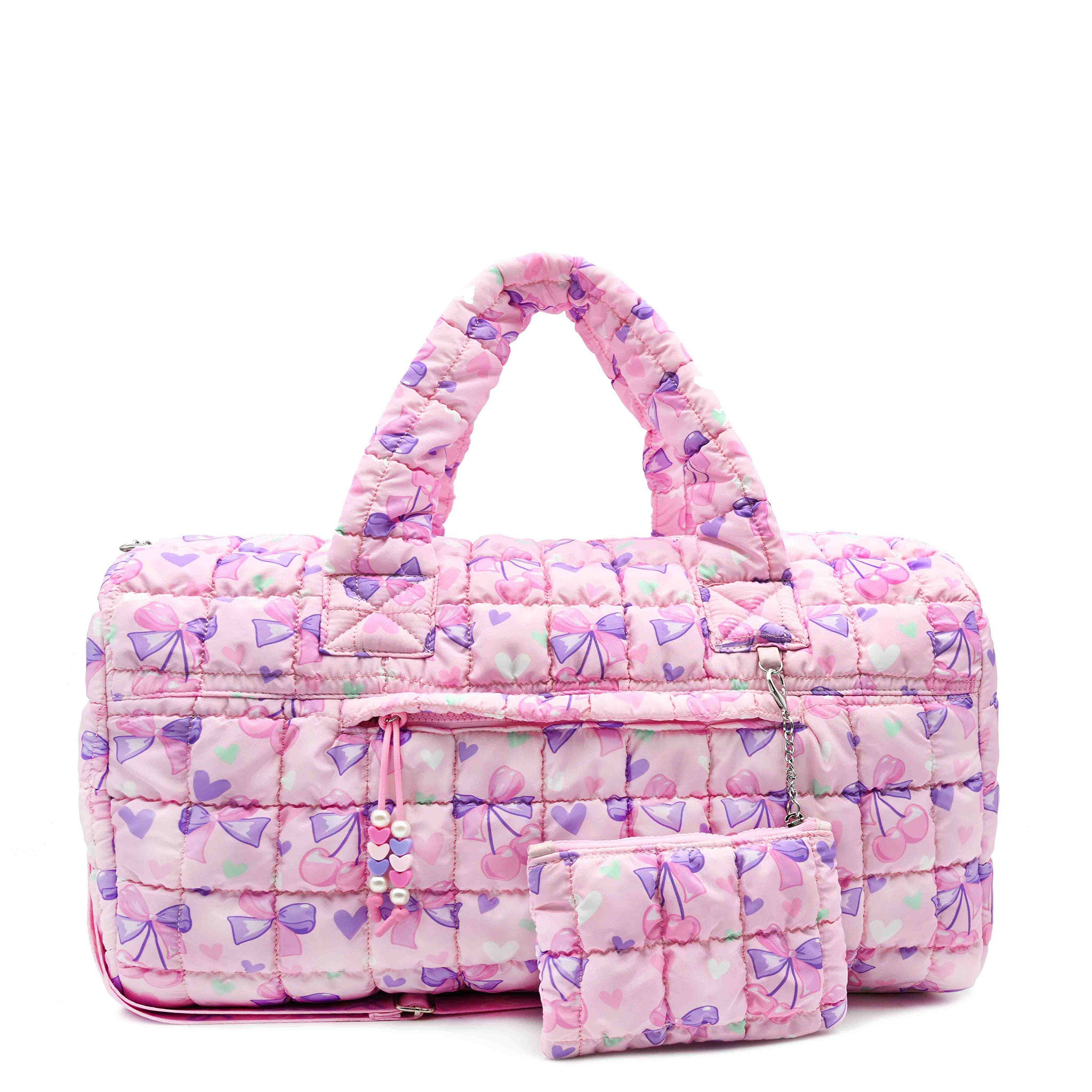 front view of a cherry & heart printed large pink quilted scrunch duffle with a detachable coin pouch
