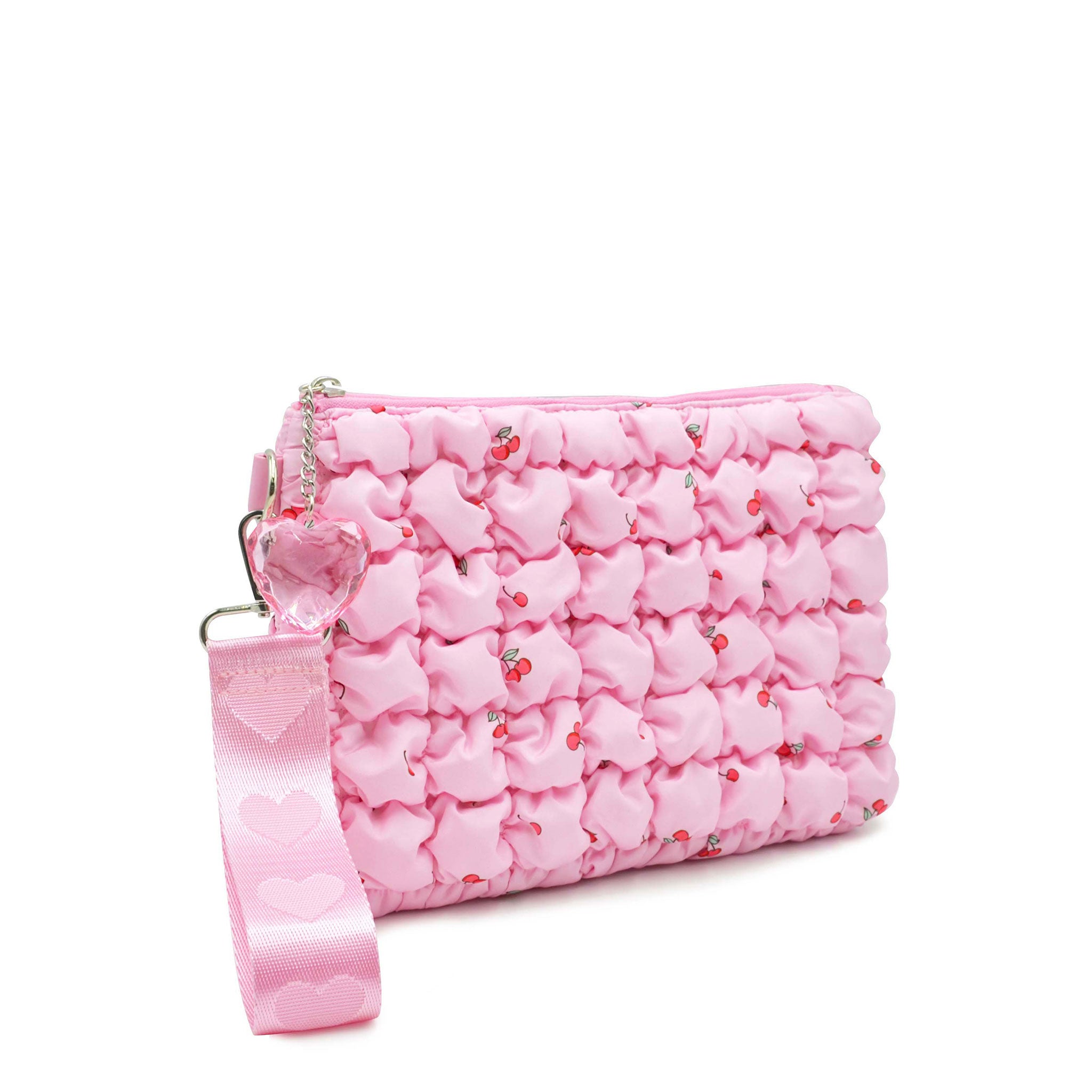 side view of a cherry printed pink quilted wristlet pouch with a heart wrist handle 