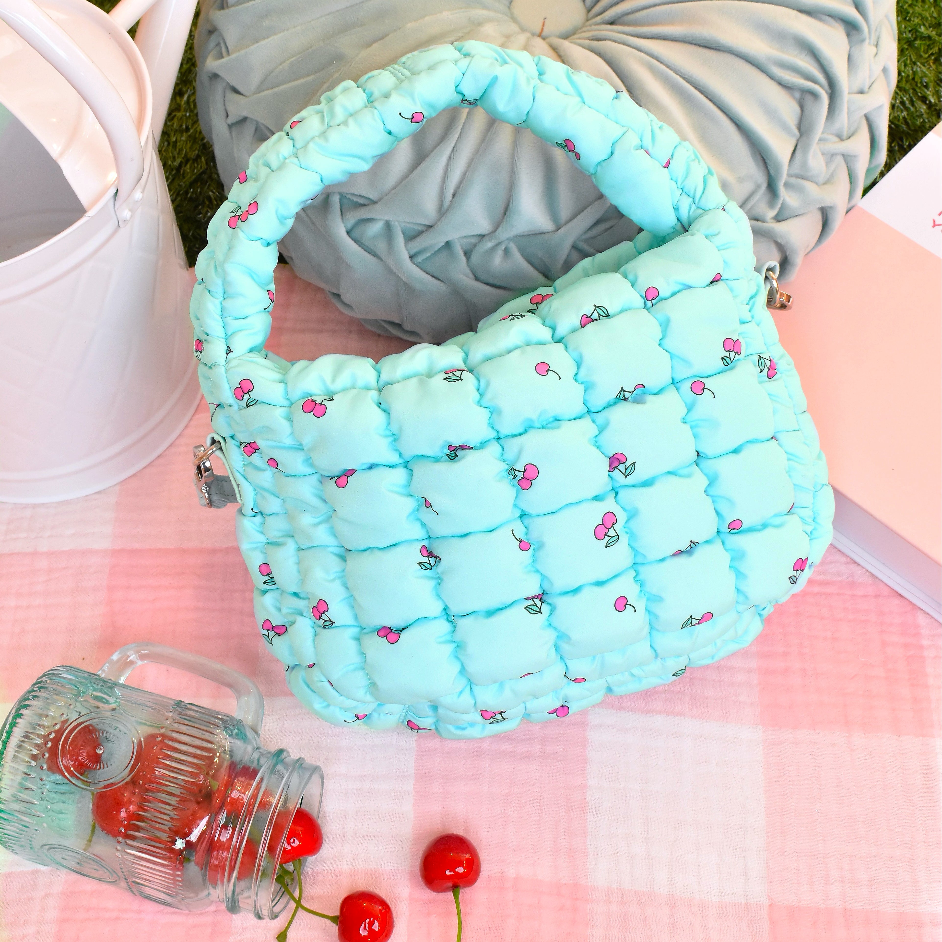 Overhead View of Light Aqua Cherry Printed Scrunch Mini Hobo Bag on Top of a Picnic Blanket