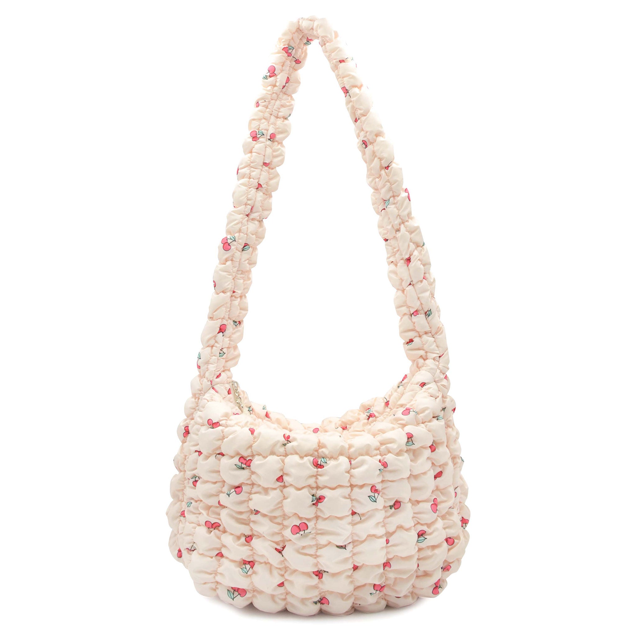 front view of a natural colored cherry print quilted nylon hobo style crossbody sling bag