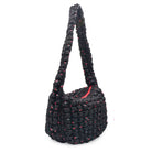 side view of a black colored cherry print quilted nylon hobo style crossbody sling bag