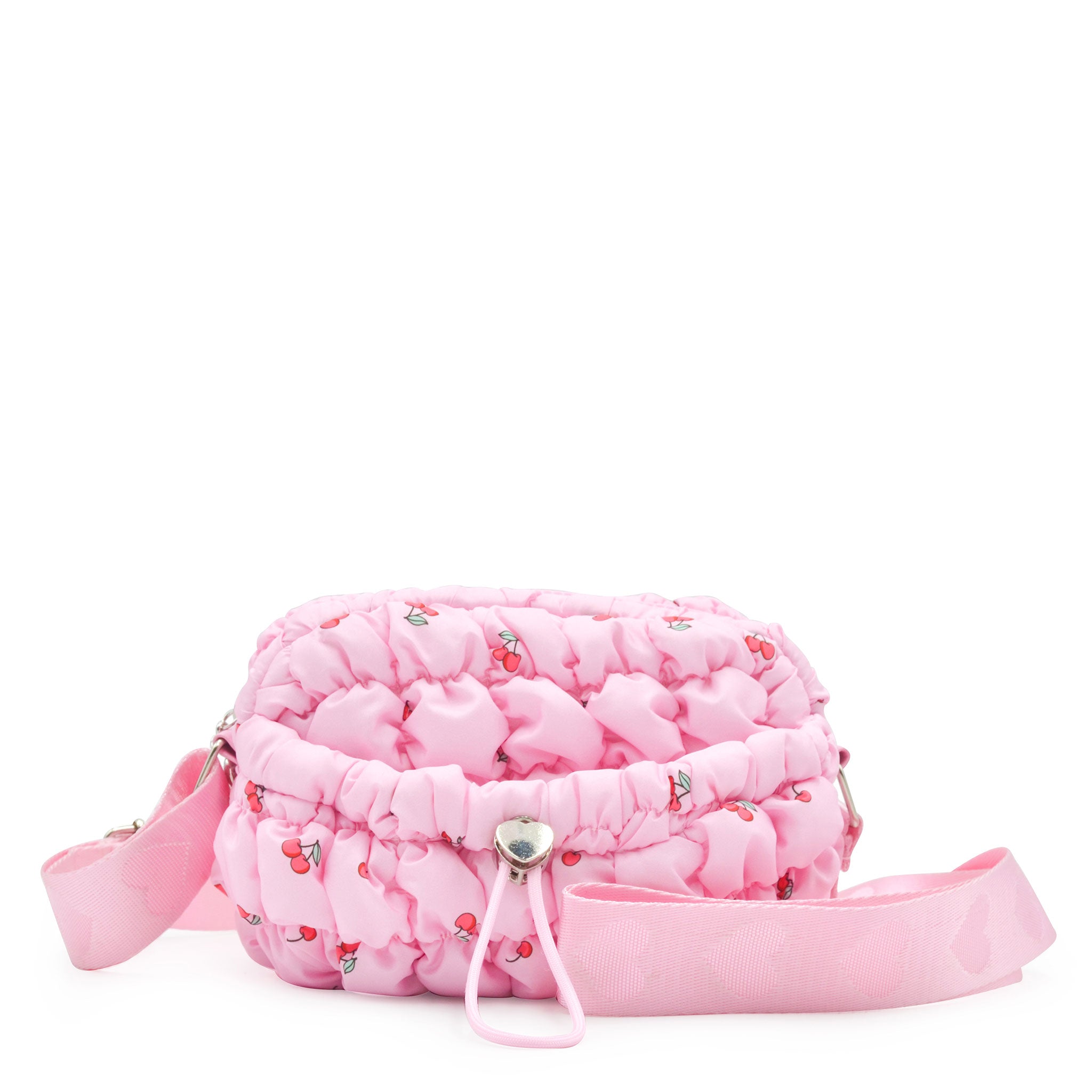 front view of a pink cherry print nylon quilted mini crossbody bag with drawstring closure and a heart strap