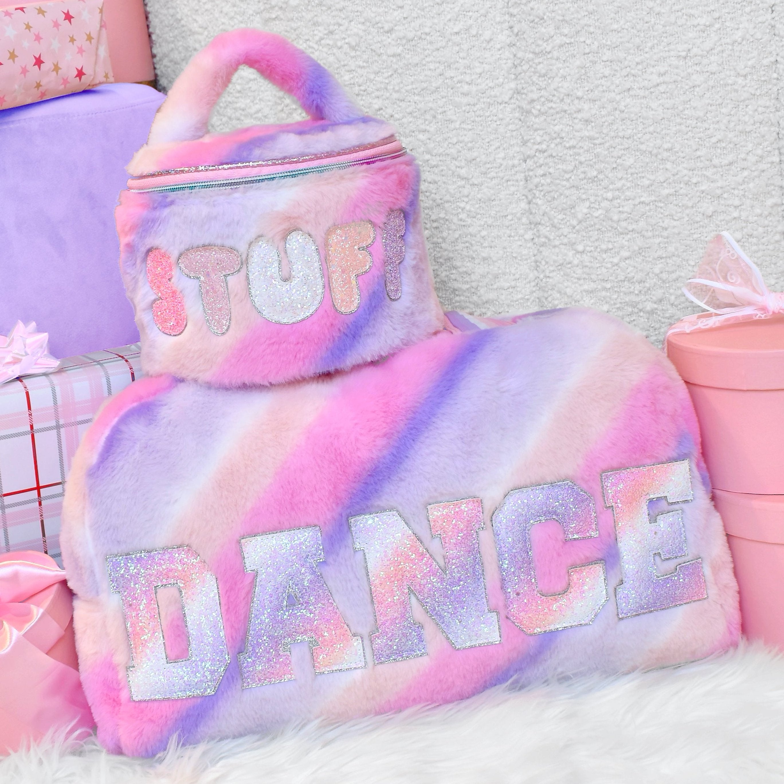 photoshoot photo of an ombre plush duffle bag with glitter varsity lettering 'Dance'