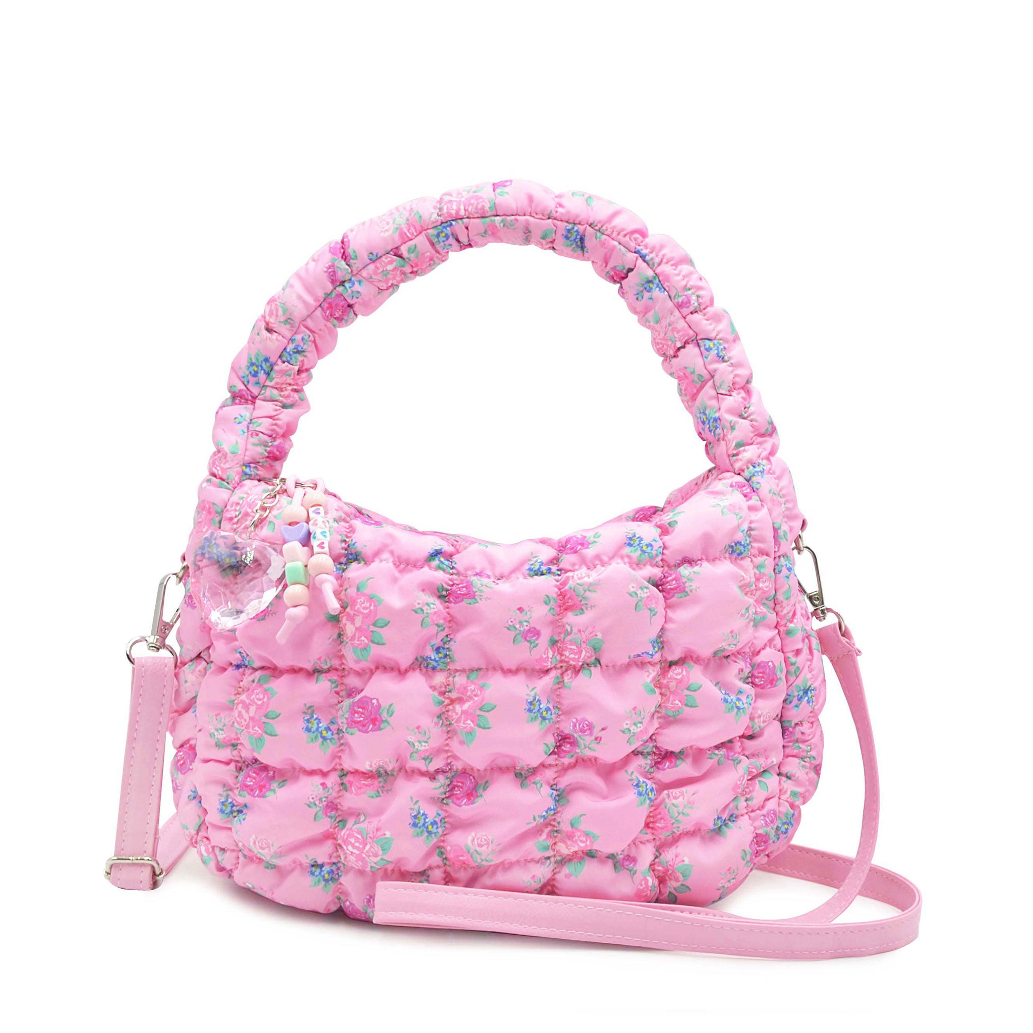 front view of a quilted nylon mini hobo crossbody bag in a floral print with a beaded keychain 