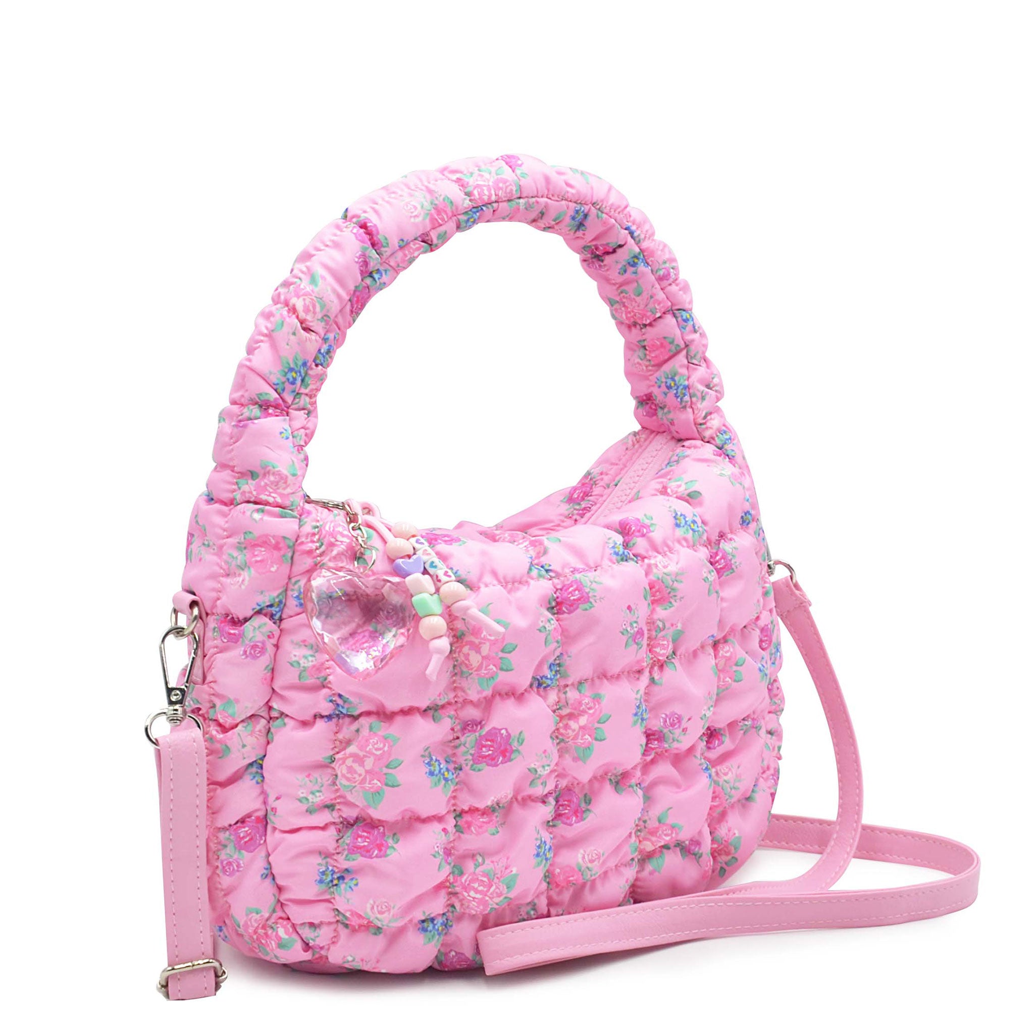 side view of a quilted nylon mini hobo crossbody bag in a floral print with a beaded keychain 