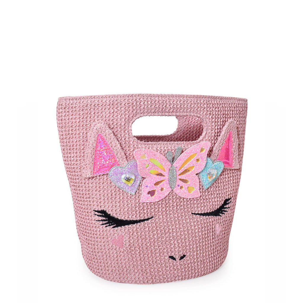 Side view of pink straw beach tote with unicorn face embellished with glitter butterfly and heart appliqués.