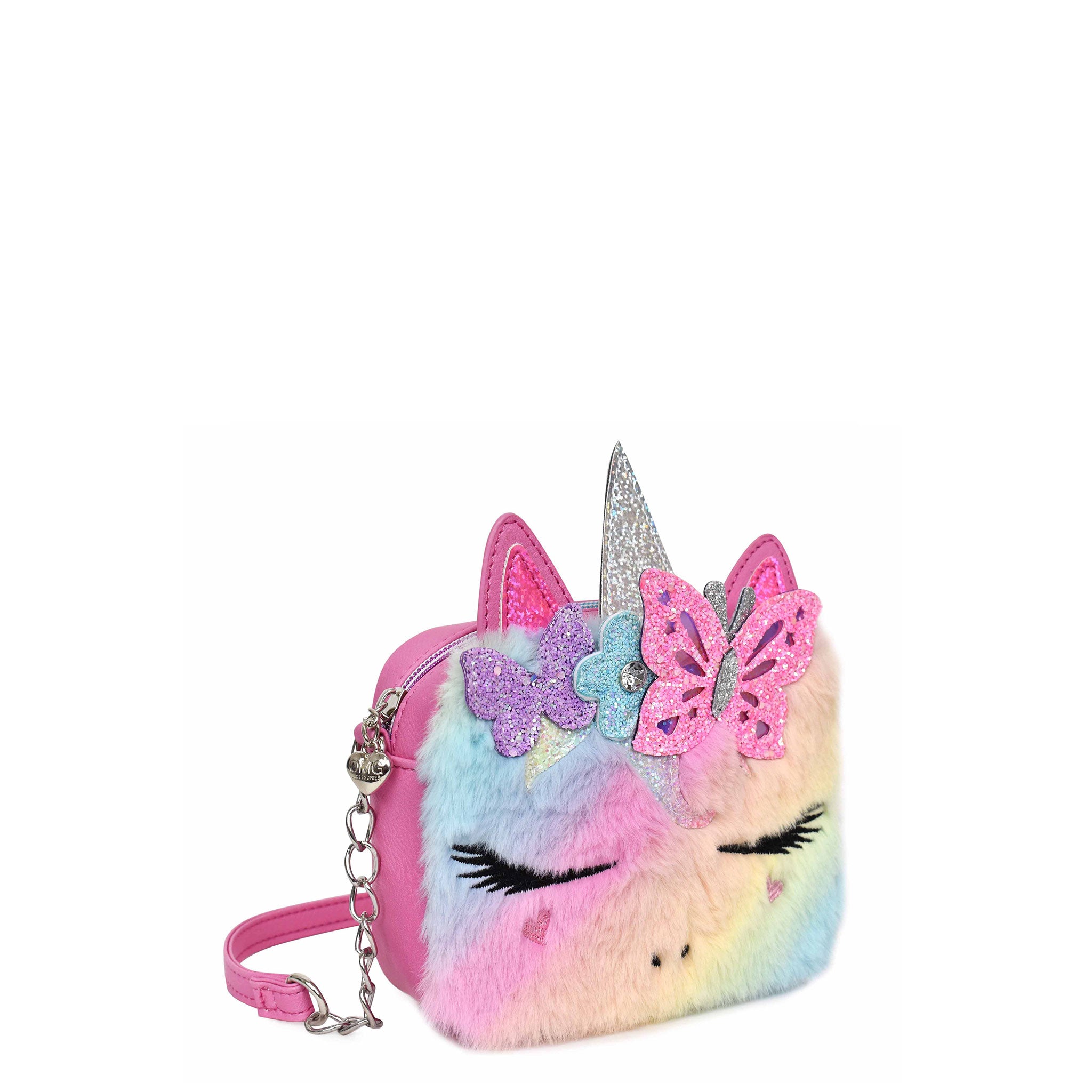Side view of a rainbow ombre plush unicorn face crossbody with a flower and butterfly crown