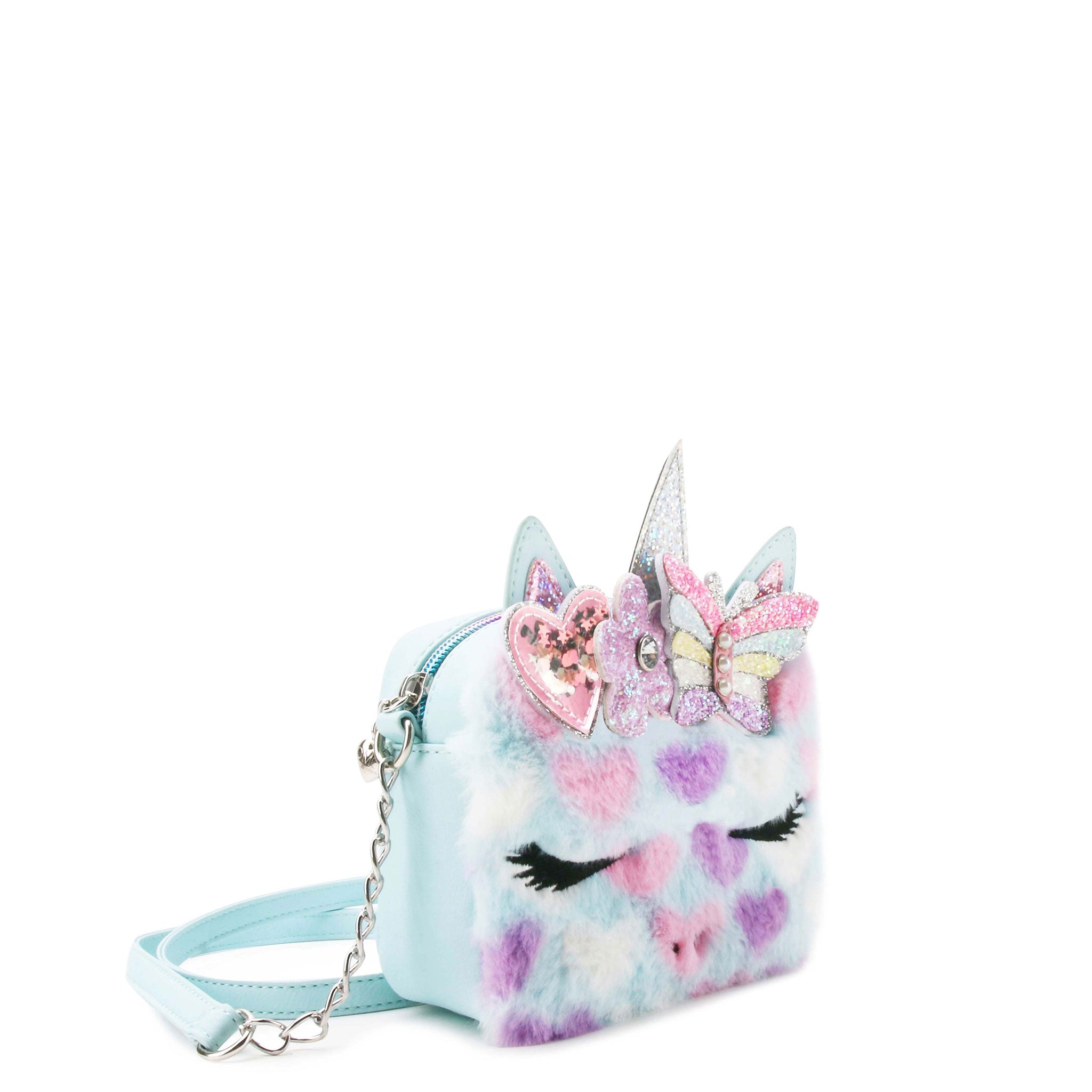 side  view of a plush heart printed unicorn face crossbody bag with a glitter butterfly crown