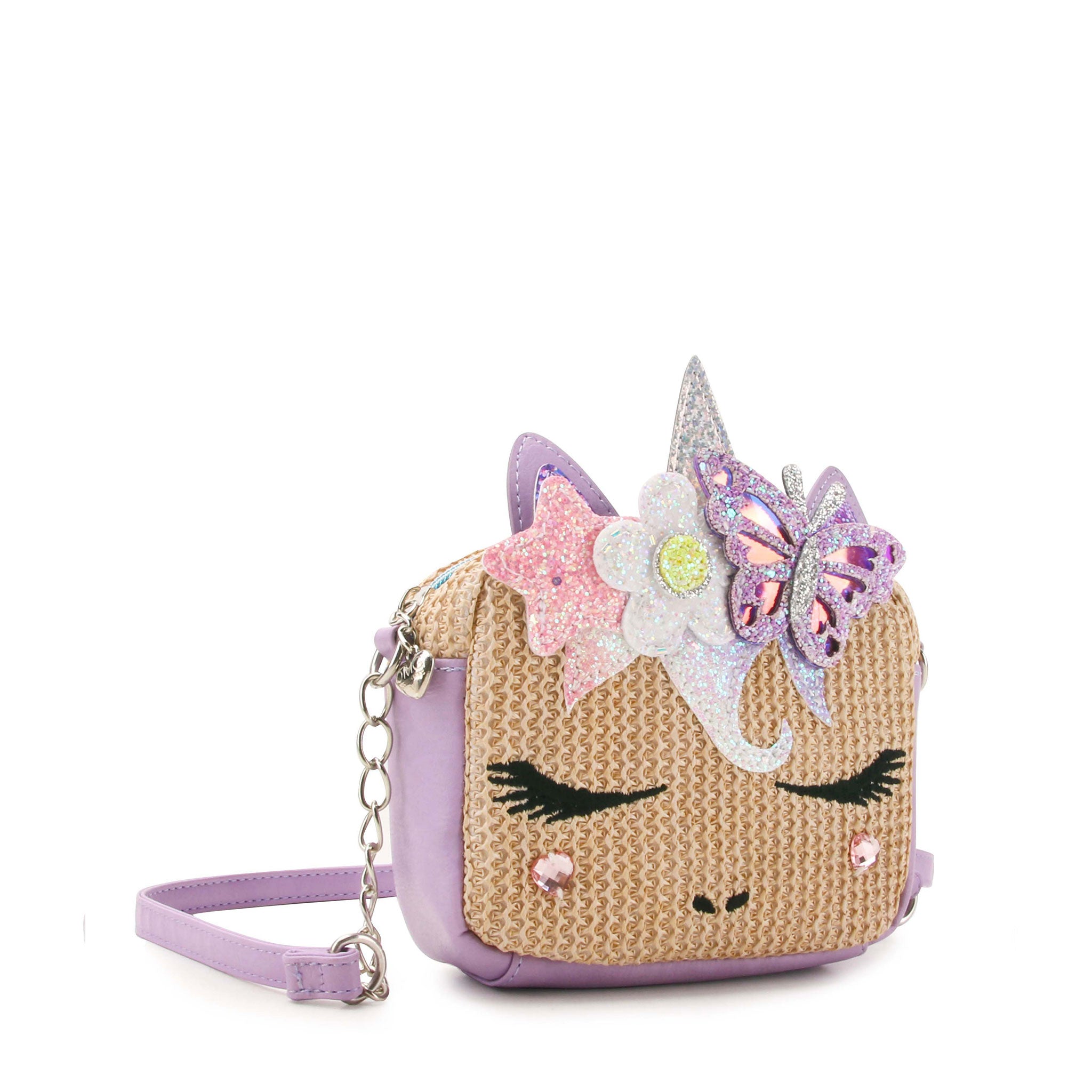 side view of a straw unicorn face  crossbody bag with a glitter butterfly and daisy crown appliqué 