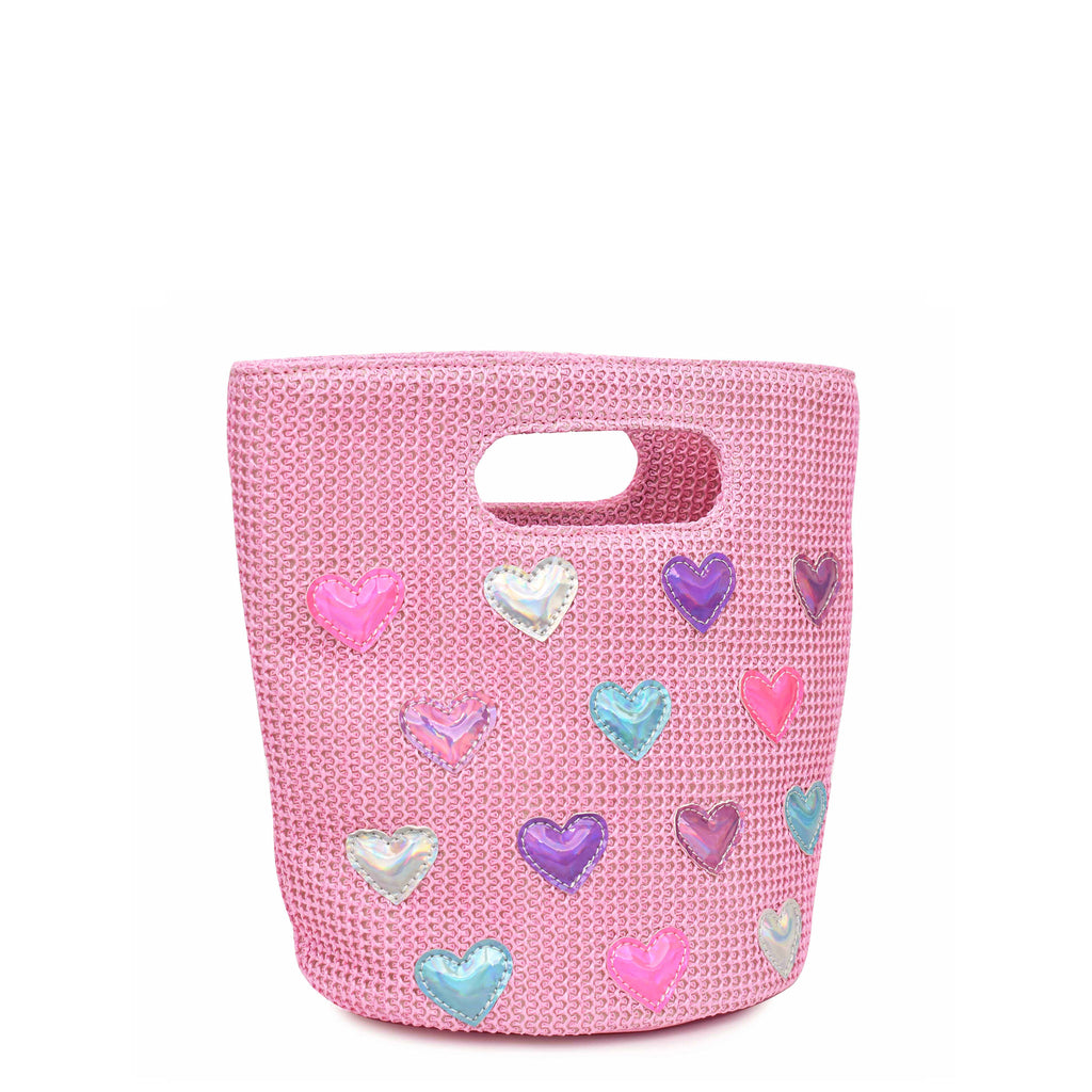 Side view of pink straw tote bag covered with metallic multi colored heart appliqués.