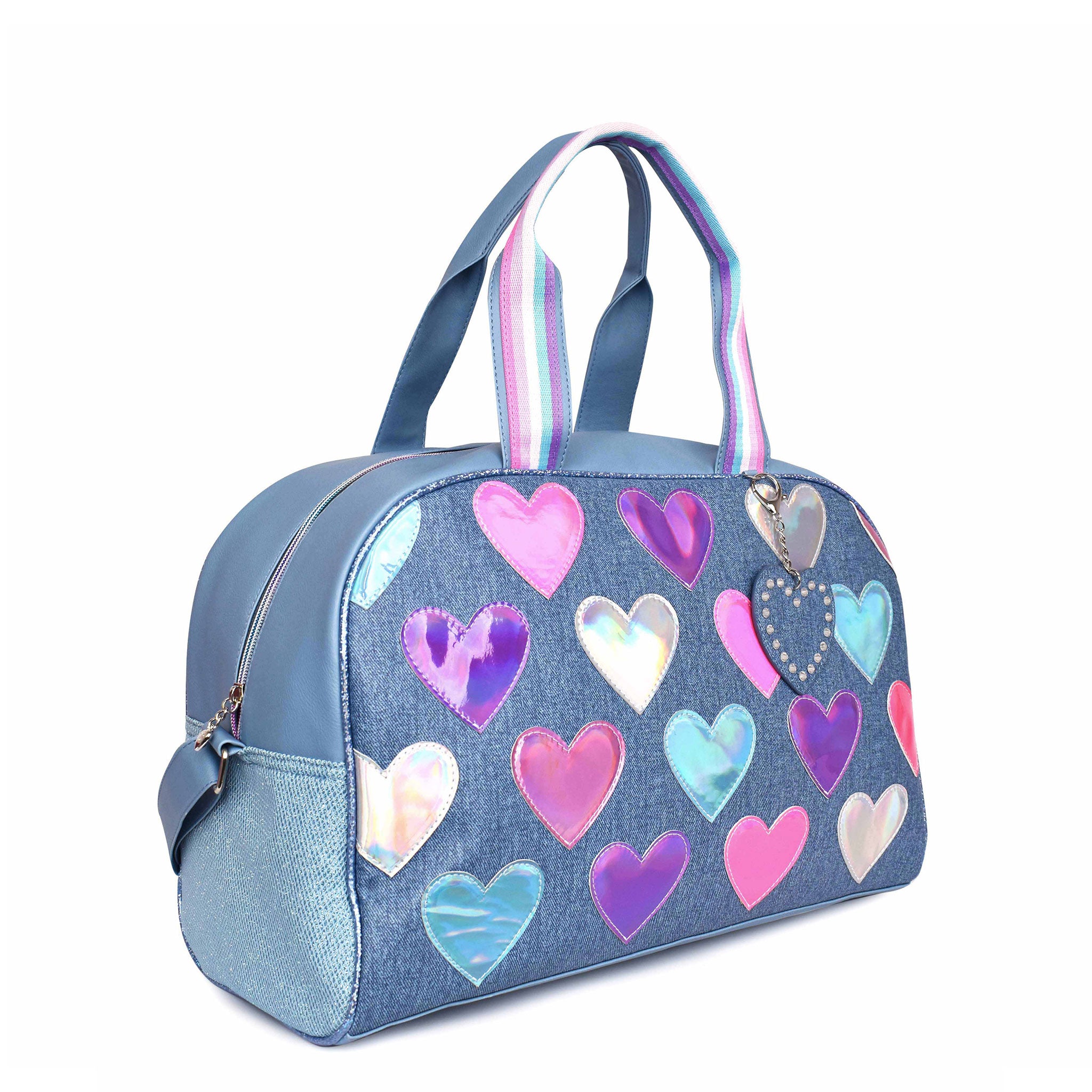 Side view of a denim large duffle bag with metallic heart patches and a heart shaped keychain