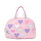 Front view of a pink, teddy sherpa medium duffle bag with chenille, sequin, and metallic heart patches.