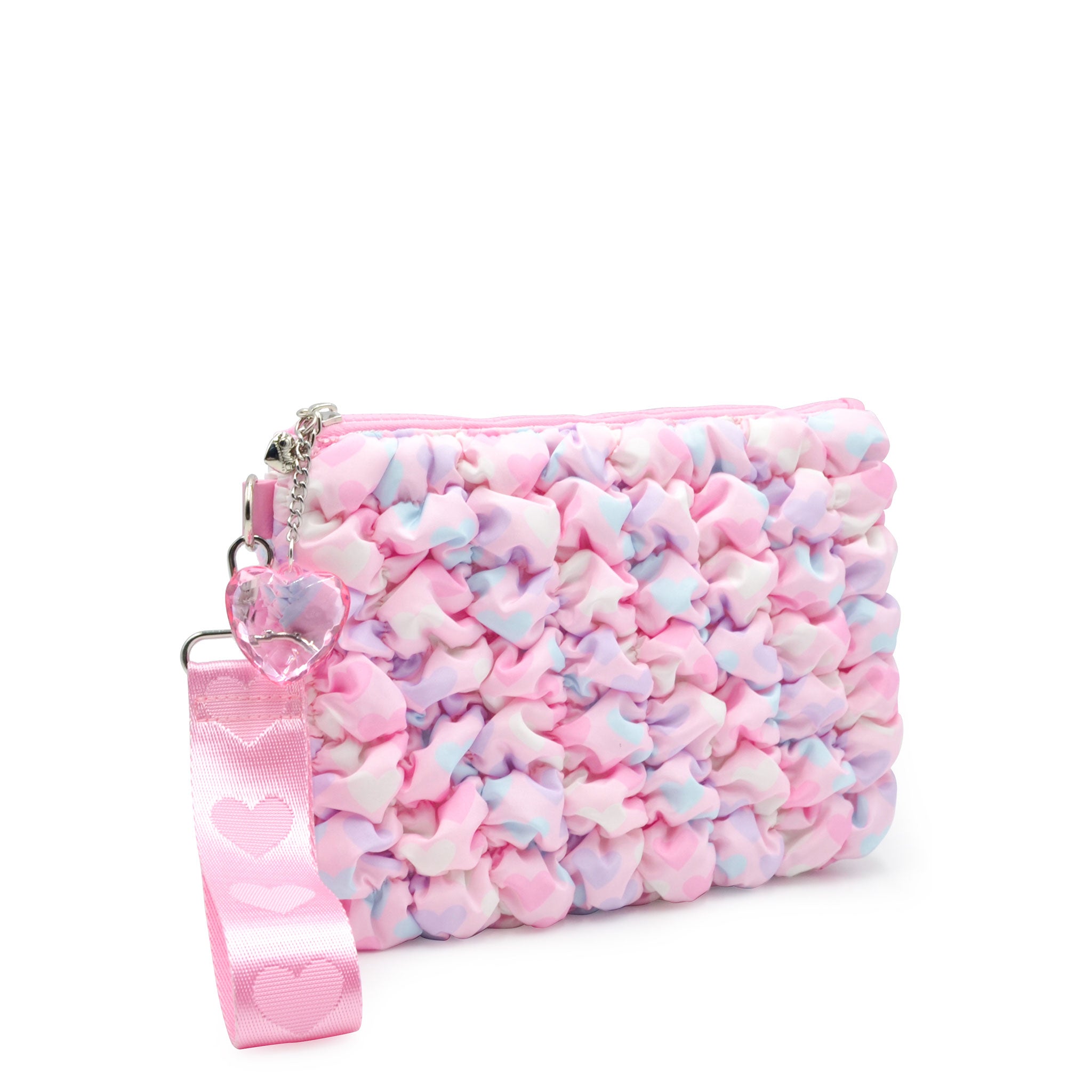 side view of a heart printed pink nylon quilted zipper pouch with detachable wristlet