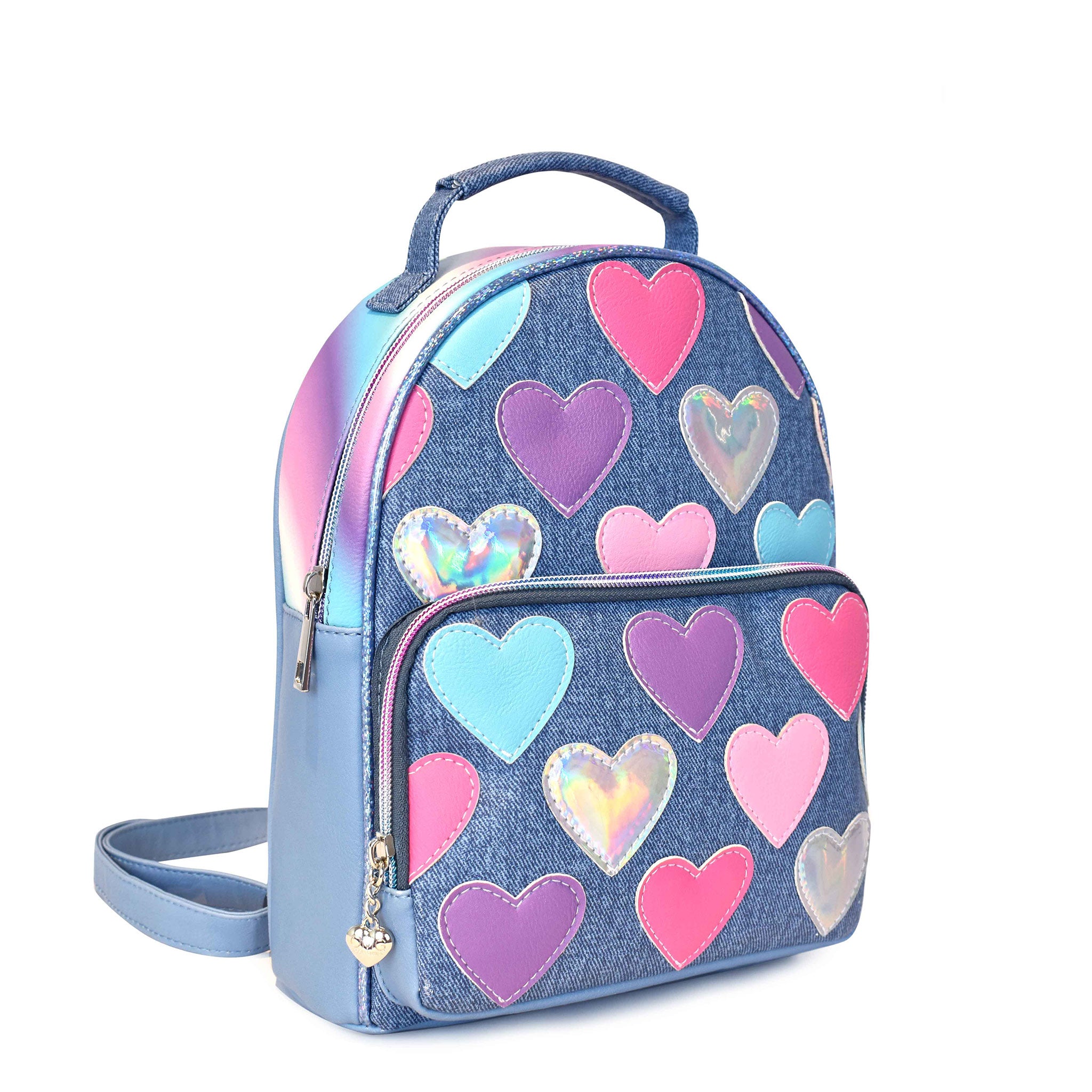 Side view of a denim mini backpack covered in heart patches with a front zipper pocket and top handle