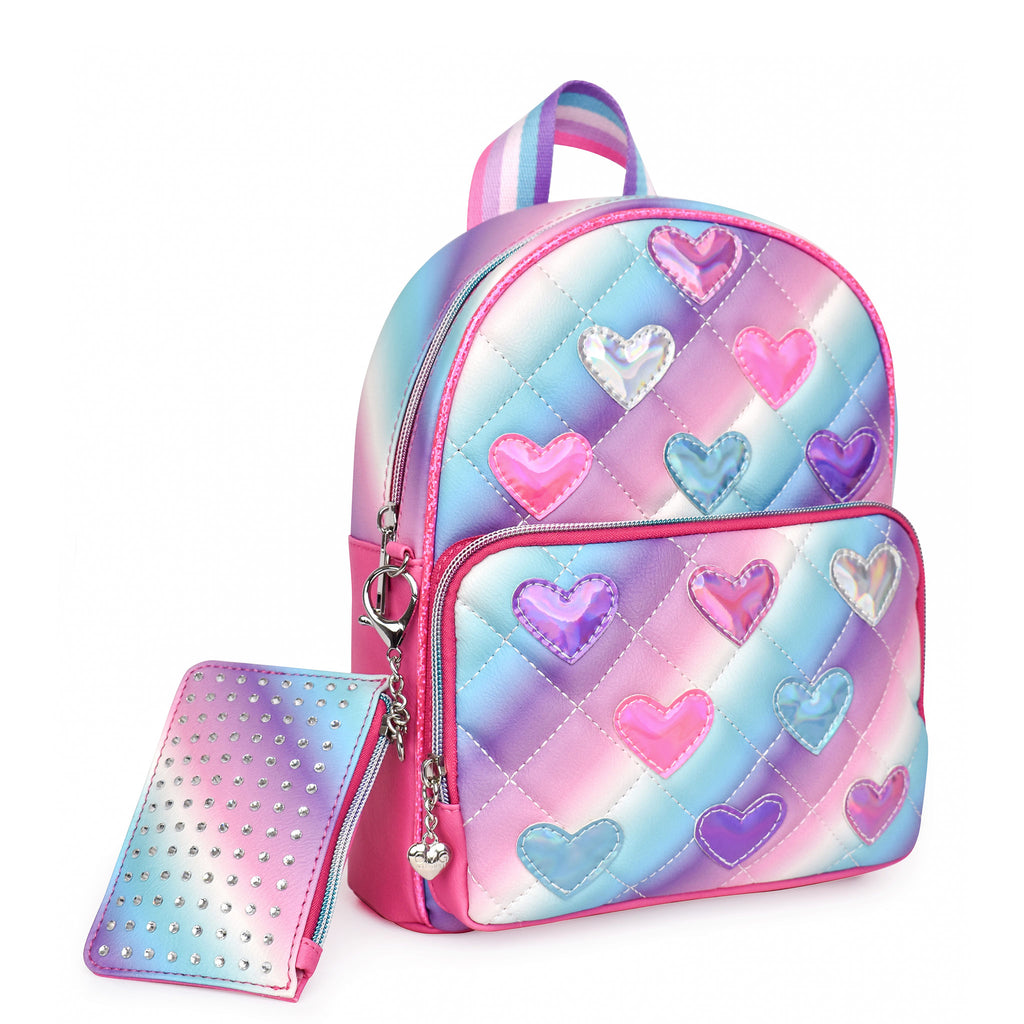 Side view of ombre quilted mini backpack with metallic heart patches and rhinestone coin purse keychain