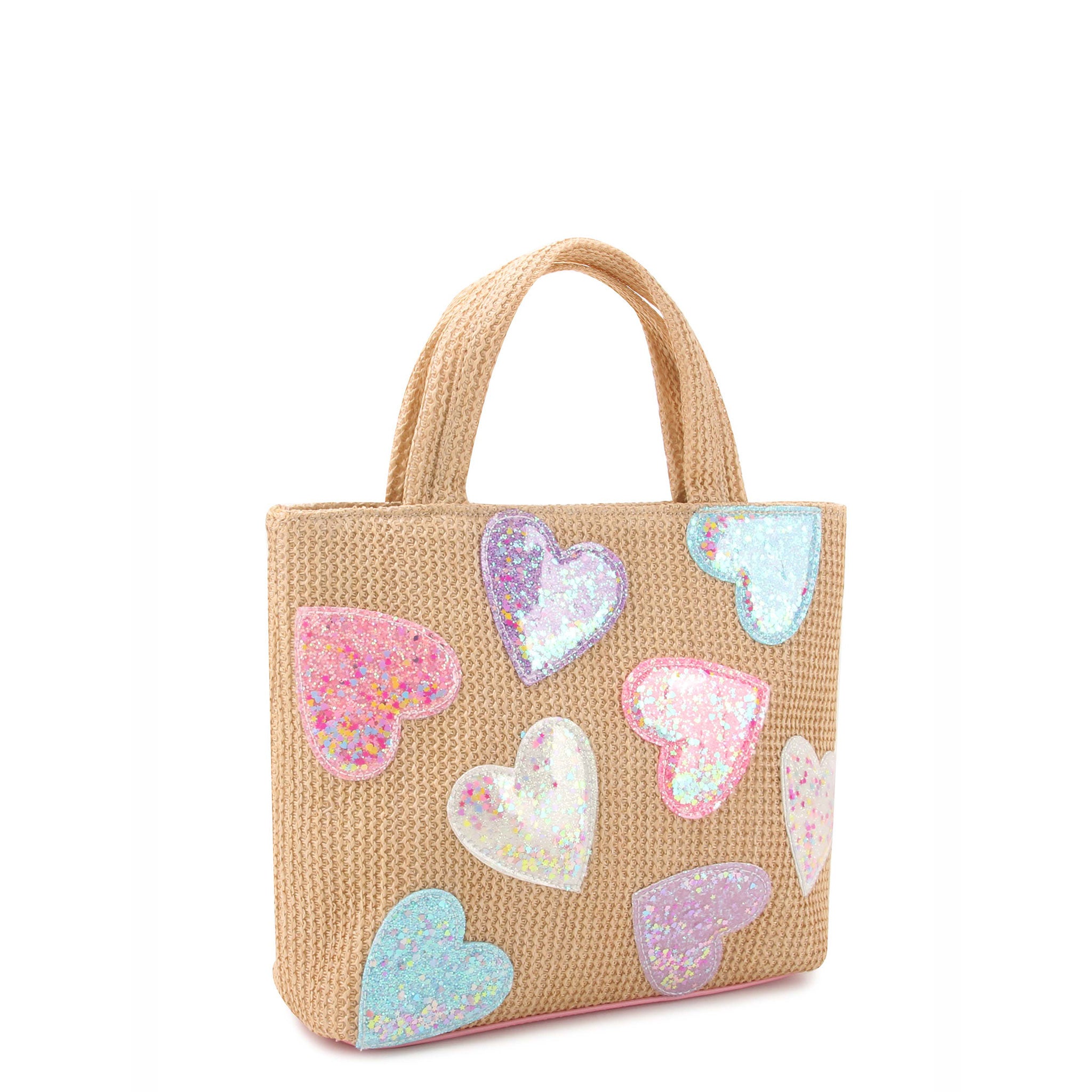 side view of a straw mini tote covered in confetti filled heart patches
