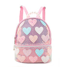 Front view of  a pink sequins mini backpack with glitter pastel heart patches and a pearl handle